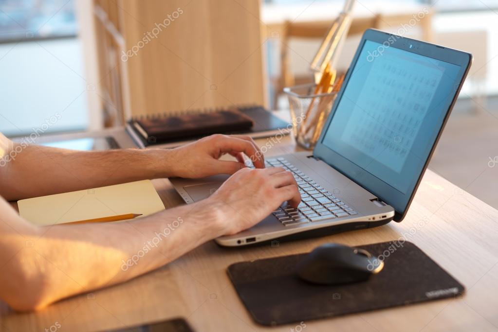 depositphotos_105895790-stock-photo-men-hands-on-notebook-business